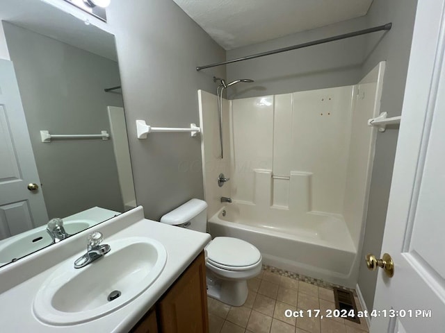 full bathroom with bathtub / shower combination, vanity, toilet, tile patterned floors, and a textured ceiling