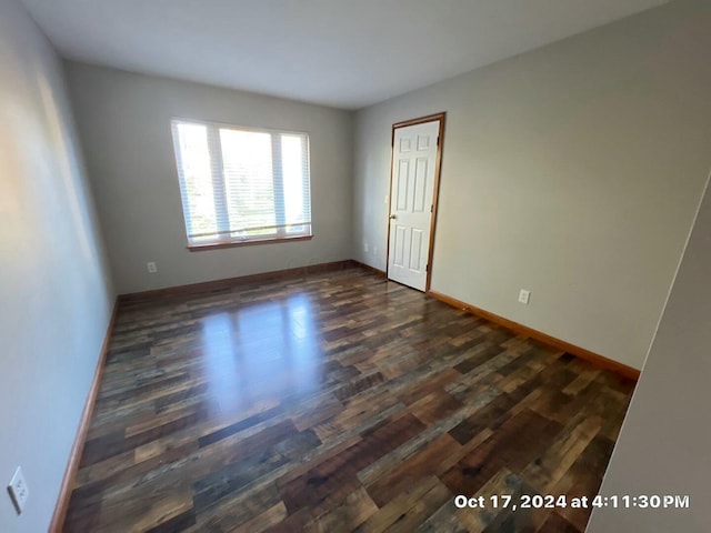 spare room with dark hardwood / wood-style flooring