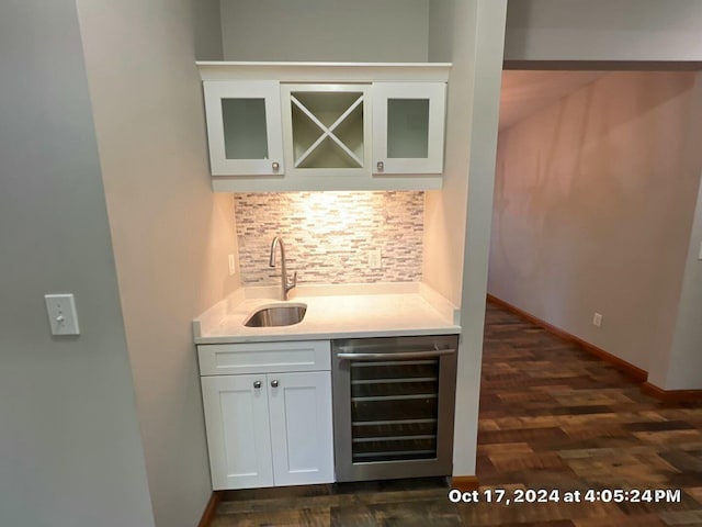 bar with sink, dark hardwood / wood-style floors, beverage cooler, decorative backsplash, and white cabinets