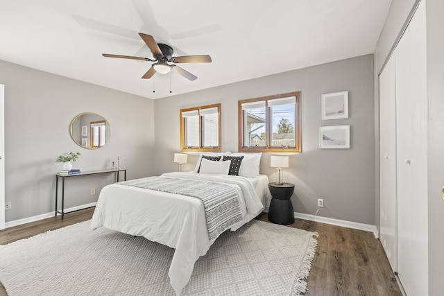 bedroom with ceiling fan, a closet, and dark wood-type flooring