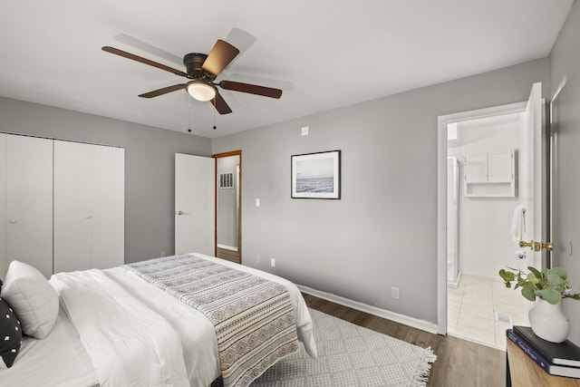 bedroom with ceiling fan, a closet, and dark hardwood / wood-style flooring