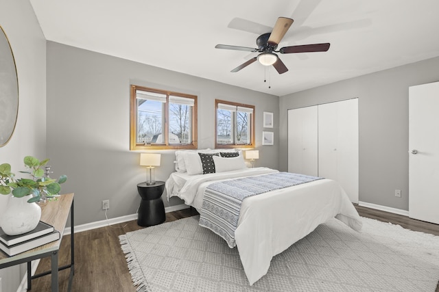 bedroom with ceiling fan, dark hardwood / wood-style floors, and a closet