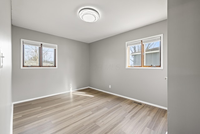 empty room with light hardwood / wood-style floors