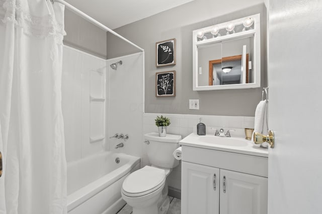 full bathroom featuring tile walls, shower / bath combination with curtain, vanity, and toilet