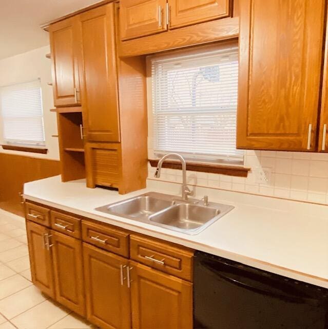 kitchen featuring sink, backsplash, dishwasher, and light tile patterned flooring