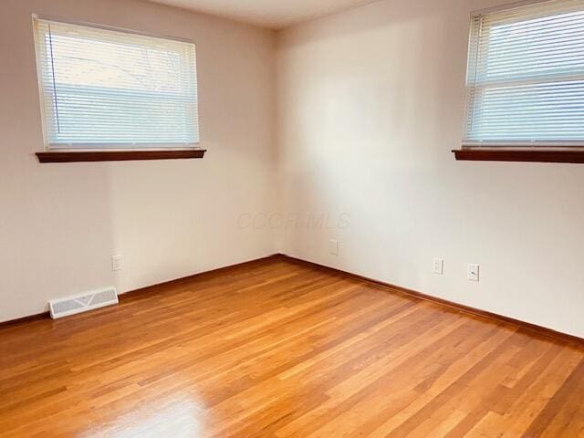 spare room with hardwood / wood-style flooring