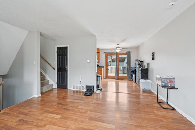 living room with light hardwood / wood-style floors and ceiling fan