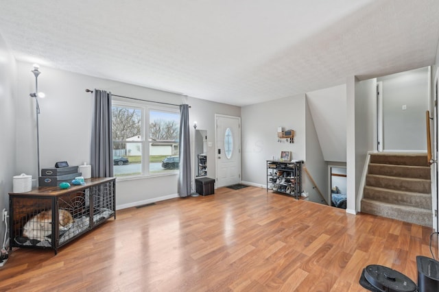 entryway featuring hardwood / wood-style flooring and a textured ceiling