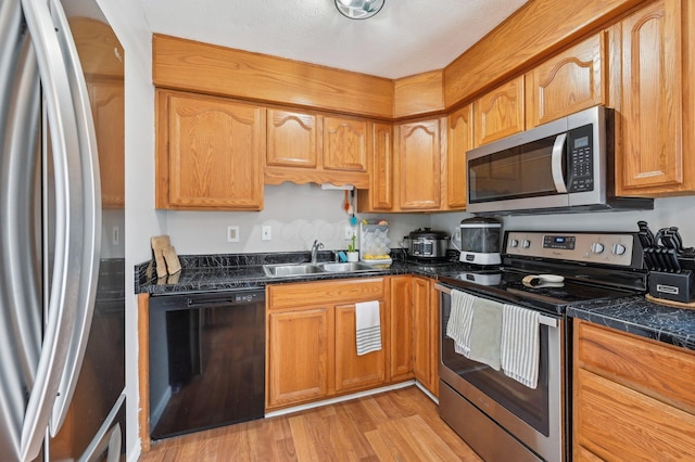 kitchen featuring sink, stainless steel appliances, and light wood-type flooring