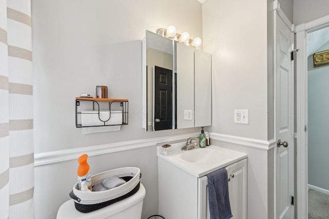 bathroom featuring vanity and toilet