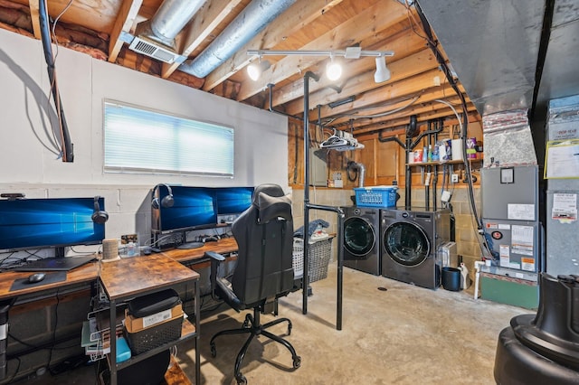 home office with washer and clothes dryer and concrete flooring