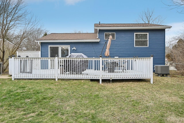 back of house with a deck, a lawn, and central air condition unit