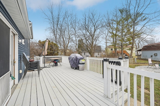 wooden terrace with a grill