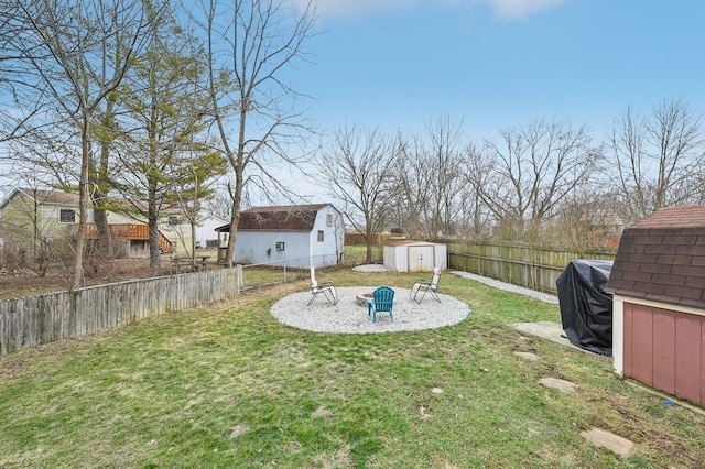 view of yard featuring a storage shed and a fire pit