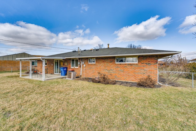 rear view of property featuring a patio, a yard, and cooling unit