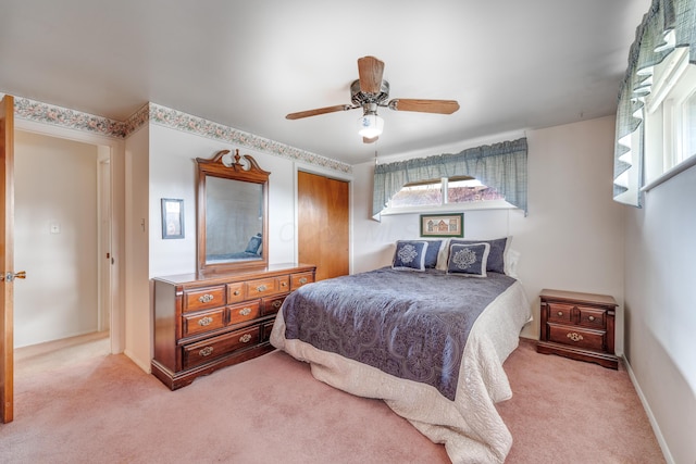 bedroom with light colored carpet, a closet, and ceiling fan