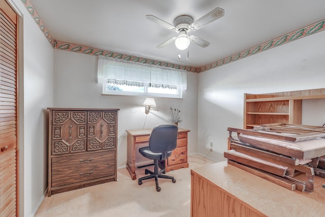 carpeted office featuring ceiling fan