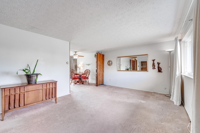 interior space with ceiling fan and a textured ceiling