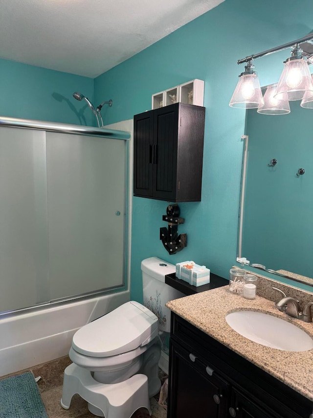 full bathroom with toilet, vanity, and bath / shower combo with glass door