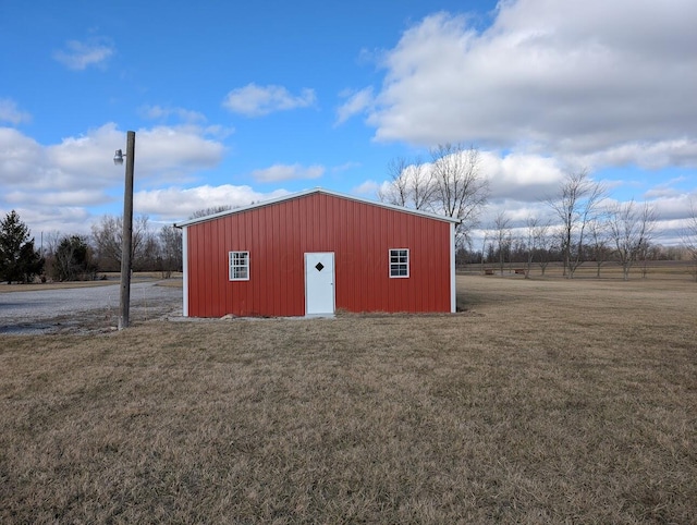 view of outdoor structure with a yard and a rural view