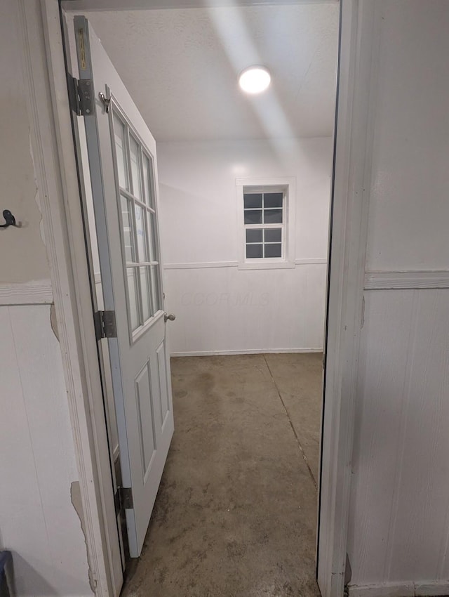 hallway with concrete floors