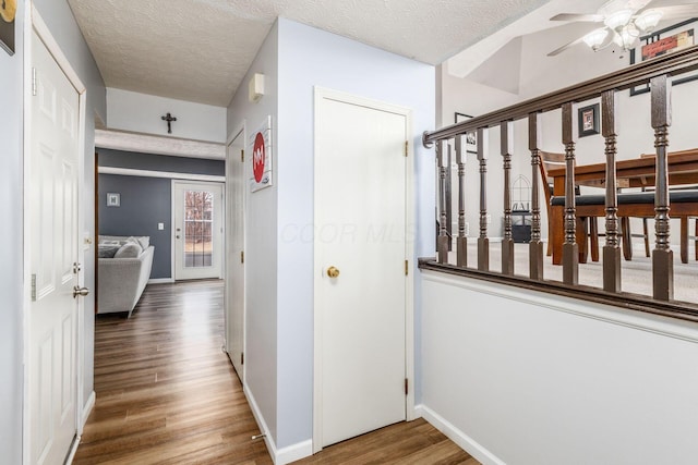 hallway featuring hardwood / wood-style flooring and a textured ceiling