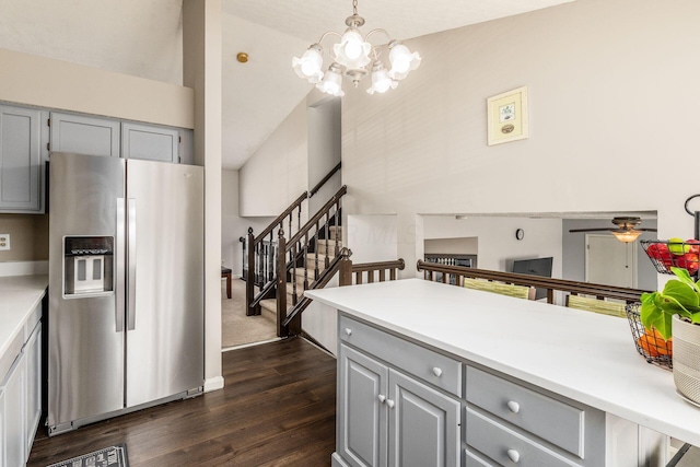 kitchen featuring stainless steel refrigerator with ice dispenser, gray cabinetry, high vaulted ceiling, hanging light fixtures, and dark hardwood / wood-style flooring