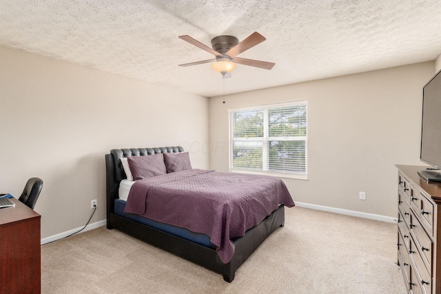 carpeted bedroom featuring a textured ceiling and ceiling fan