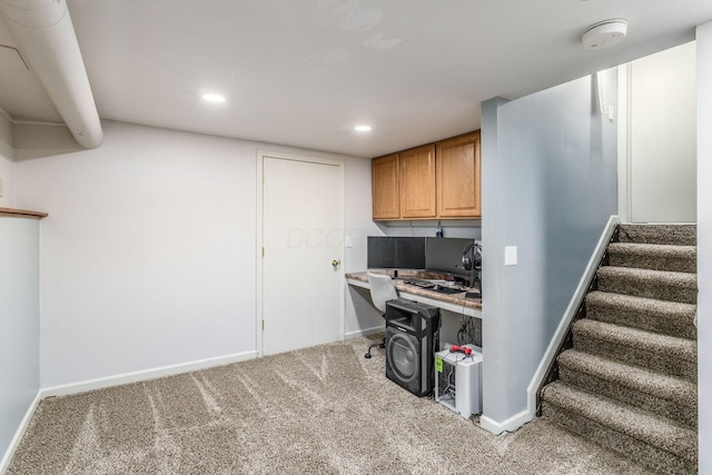 carpeted office featuring built in desk