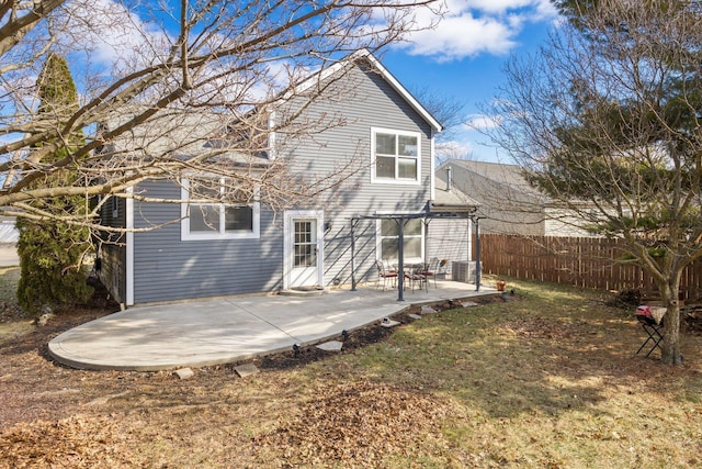 back of property with a patio, a pergola, and a lawn