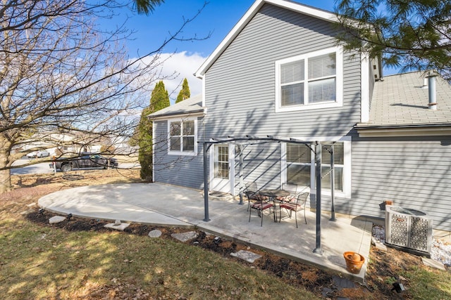 rear view of property with central AC unit and a patio