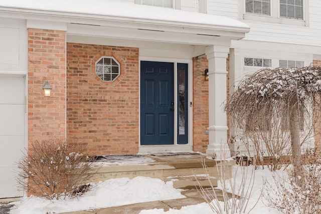 view of snow covered property entrance