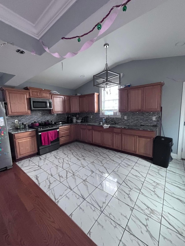 kitchen with tasteful backsplash, hanging light fixtures, vaulted ceiling, and stainless steel appliances