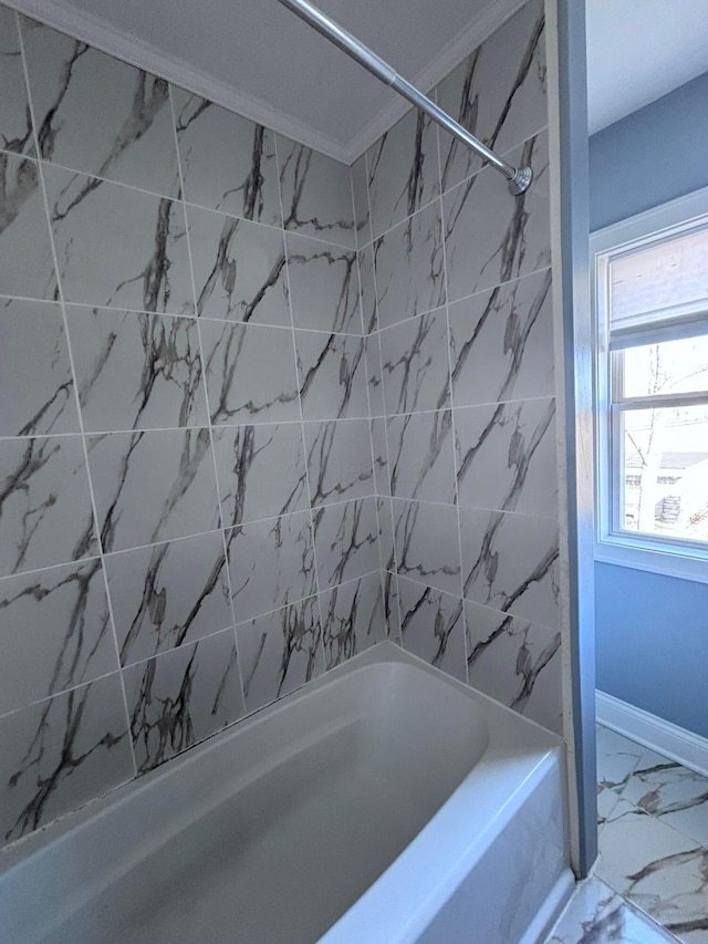 bathroom with baseboards, bathing tub / shower combination, and marble finish floor