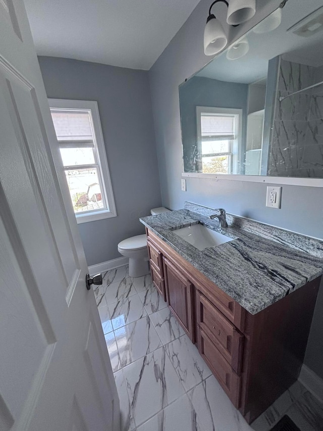 full bathroom featuring vanity, toilet, plenty of natural light, and marble finish floor