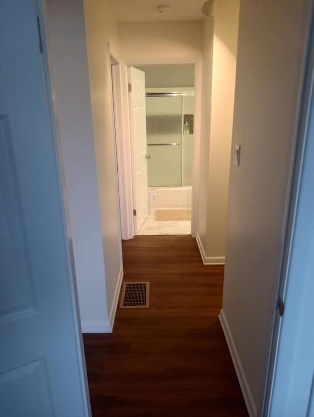 hallway with dark hardwood / wood-style flooring