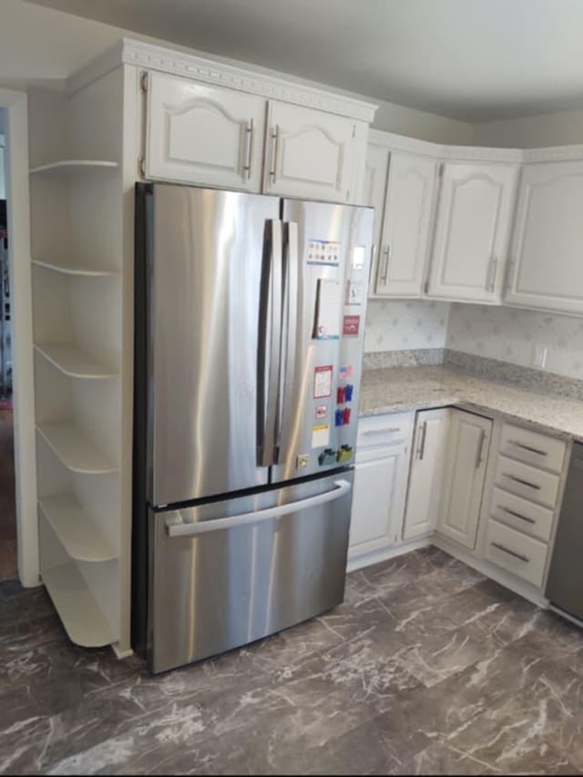 kitchen featuring stainless steel appliances and white cabinets