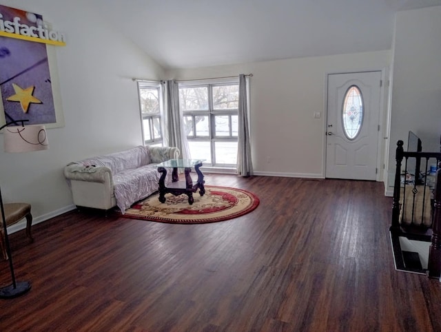 entrance foyer featuring lofted ceiling and dark hardwood / wood-style flooring