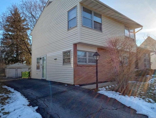 view of snowy exterior featuring a garage