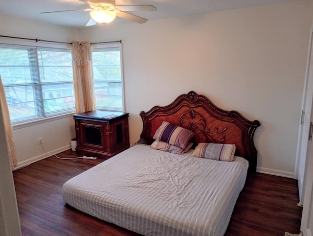 bedroom with ceiling fan and dark hardwood / wood-style flooring