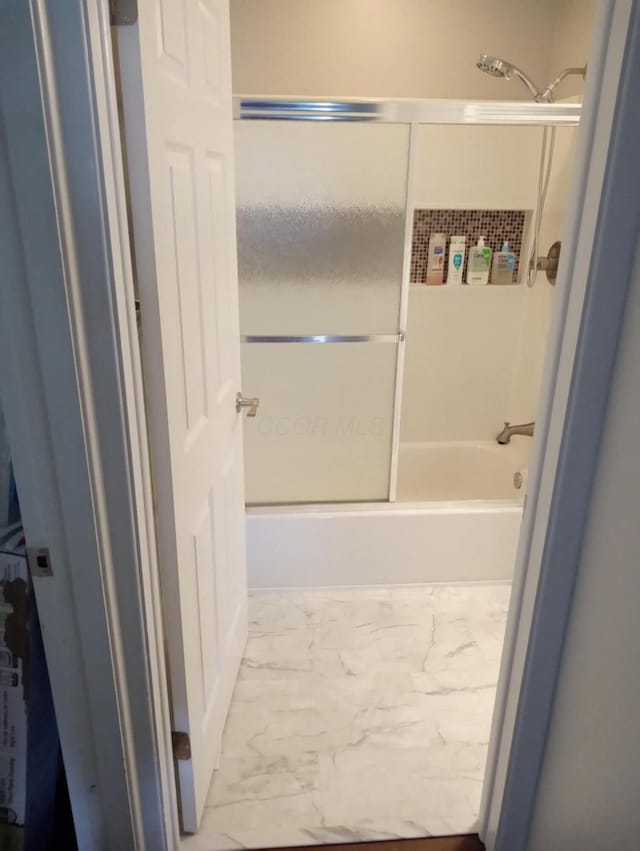 bathroom featuring shower / bath combination with glass door