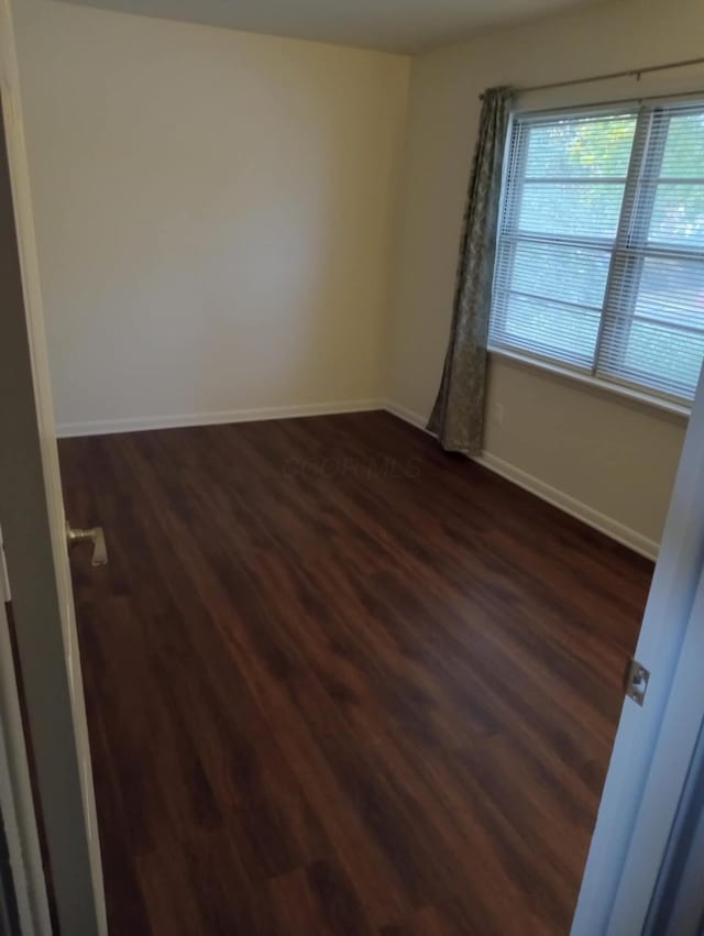 unfurnished room featuring dark hardwood / wood-style floors