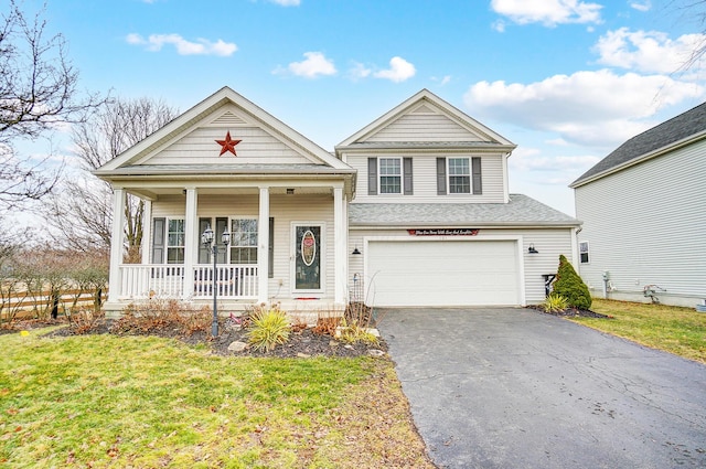 view of front of property featuring an attached garage, covered porch, driveway, and a front yard