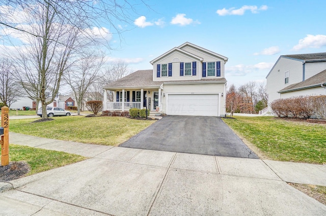 front facade with a garage, a front yard, and covered porch