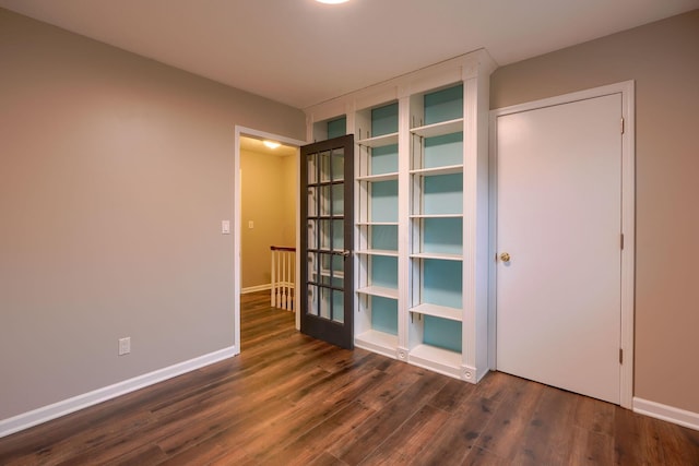 unfurnished room featuring dark hardwood / wood-style flooring