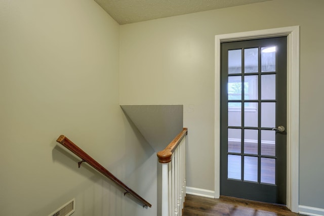 interior space featuring dark hardwood / wood-style floors and a textured ceiling