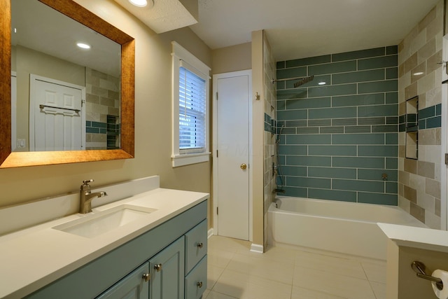 bathroom with tiled shower / bath, vanity, and tile patterned floors