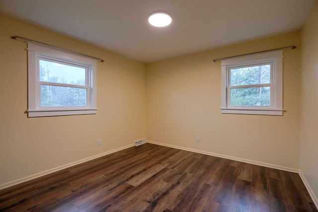 unfurnished room featuring dark wood-type flooring