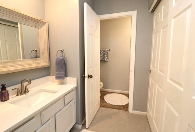 bathroom featuring vanity and toilet