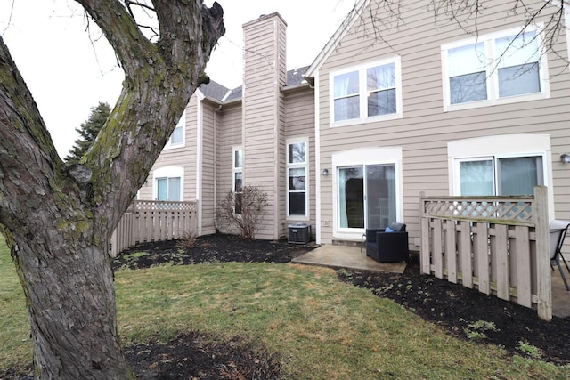 back of property featuring a yard and a patio